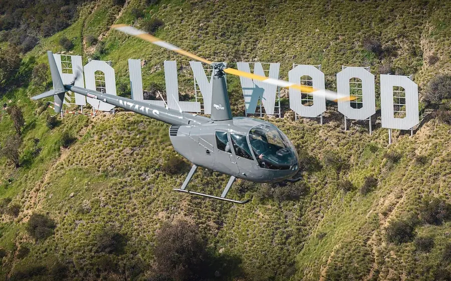 A helicopter beside the Hollywood Sign in Los Angeles